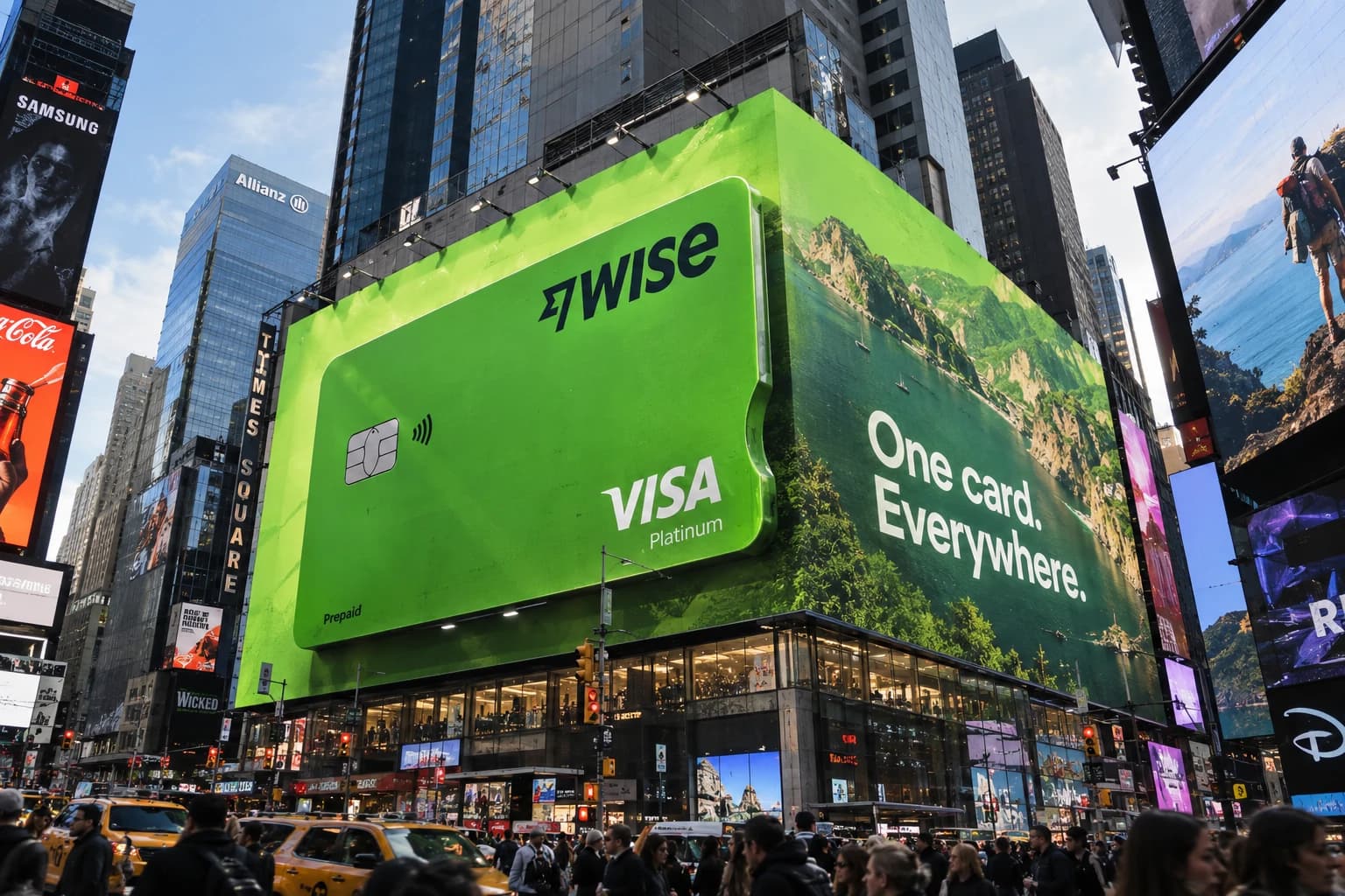A giant green Wise card on a billboard in Times Square with the line “One card. Everywhere.”