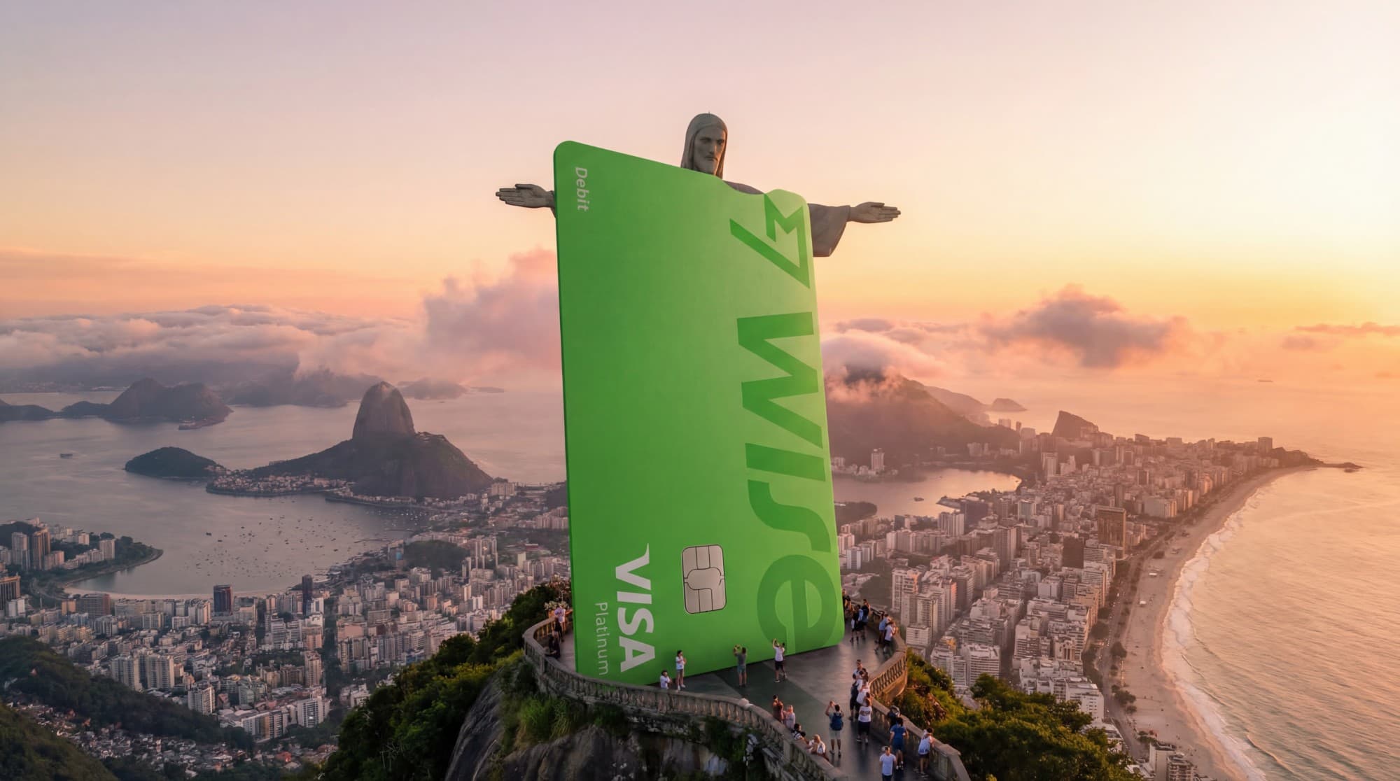A giant Wise card in front of Christ the Redeemer overlooking Rio de Janeiro at sunset